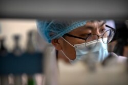 An employee works in a research and development lab of Beijing Applied Biological Technologies, a firm which is developing COVID-19 molecular diagnostic test kits, during a government organized tour for journalists in Beijing,May 14, 2020.