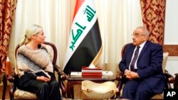 FILE - A photo released by the Iraqi Prime Minister Media Office, shows Iraqi acting Prime Minister Adil Abdul-Mahdi meeting with the U.N. special representative to Iraq Jeanine Hennis-Plasschaert, in Baghdad, Iraq, Jan. 6, 2020. 