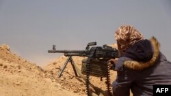 FILE - Forces loyal to Yemen's Saudi-backed government get into position during clashes with Houthi rebel fighters in Yemen's northeastern province of Marib, March 4, 2021.