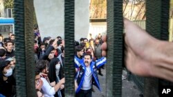 FILE - University students attend an anti-government protest at Iran's Tehran University, Dec. 30, 2017. The photo, obtained by the Associated Press, was taken by an individual not employed by AP. 