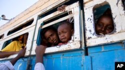 Refugees who fled the conflict in Ethiopia's Tigray region ride a bus going to the Village 8 temporary shelter, near the Sudan-Ethiopia border, in Hamdayet, eastern Sudan, Dec. 1, 2020. 