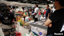 Warga memborong bahan makan di sebuah supermarket di Singapura karena khawatir terjadi kelangkaan setelah Malaysia mengumumkan penutupan perbtasan untuk mengatasi virus corona, 17 Maret 2020. (Foto: Reuters)