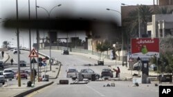 An impromptu roadblock is seen through a car windscreen in Tripoli, Libya, February 26, 2011