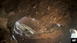 This Dec. 9, 2019 photo provided by U.S. Customs and Border Protection (CBP) shows an access point to a tunnel between Nogales, Mexico, and Nogales, Ariz., seen from the U.S. side. 