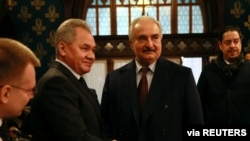 FILE - Commander of the Libyan National Army (LNA) Khalifa Haftar shakes hands with Russian Defence Minister Sergei Shoigu before talks in Moscow, Russia January 13, 2020.