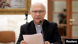 Chilean bishop Luis Fernando Ramos Perez reads a statement during a news conference after a meeting with Pope Francis at the Vatican, May 18, 2018. 