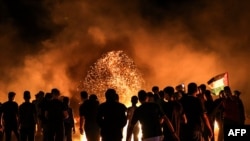 Palestinian protesters burns tires following a demonstration along the border between the Gaza Strip and Israel east of Gaza City on Aug. 28, 2021. 