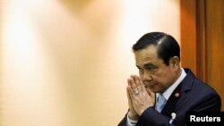 FILE - Thai Army chief General Prayuth Chan-ocha gestures in a traditional greeting during the start of a National Legislative Assembly meeting, Bangkok, August 2014.