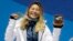 FILE - women's halfpipe gold medalist Chloe Kim, of the United States, poses during the medals ceremony at the 2018 Winter Olympics, in Pyeongchang, South Korea, Feb. 13, 2018.