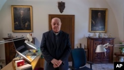 Prefect of the Archivio Apostolico Vaticano, Bishop Sergio Pagano poses in his office at The Vatican, Wednesday, Feb. 14, 2024, after an interview with The Associated Press. (AP Photo/Domenico Stinellis)