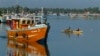  Lankan fishermen stand on a fishing vessel as it leaves a fishery harbor in Negombo, Negombo, outskirts of Colombo, Sri Lanka, Wednesday, Oct.15, 2014. In its fight against illegal fishing activities worldwide, the European Commissioner for Maritime Affa