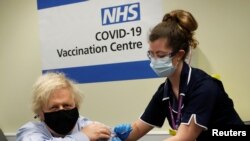 British Prime Minister Boris Johnson receives a dose of the Oxford/AstraZeneca COVID-19 vaccine, amid the coronavirus disease pandemic, in London, March 19, 2021.
