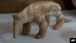 A Karaja culture ceramic depicting an armadillo rescued from the ashes of the fire that swept through Rio’s National Museum in September, is displayed during a media presentation, in Rio de Janeiro, Brazil, Dec. 10, 2018.