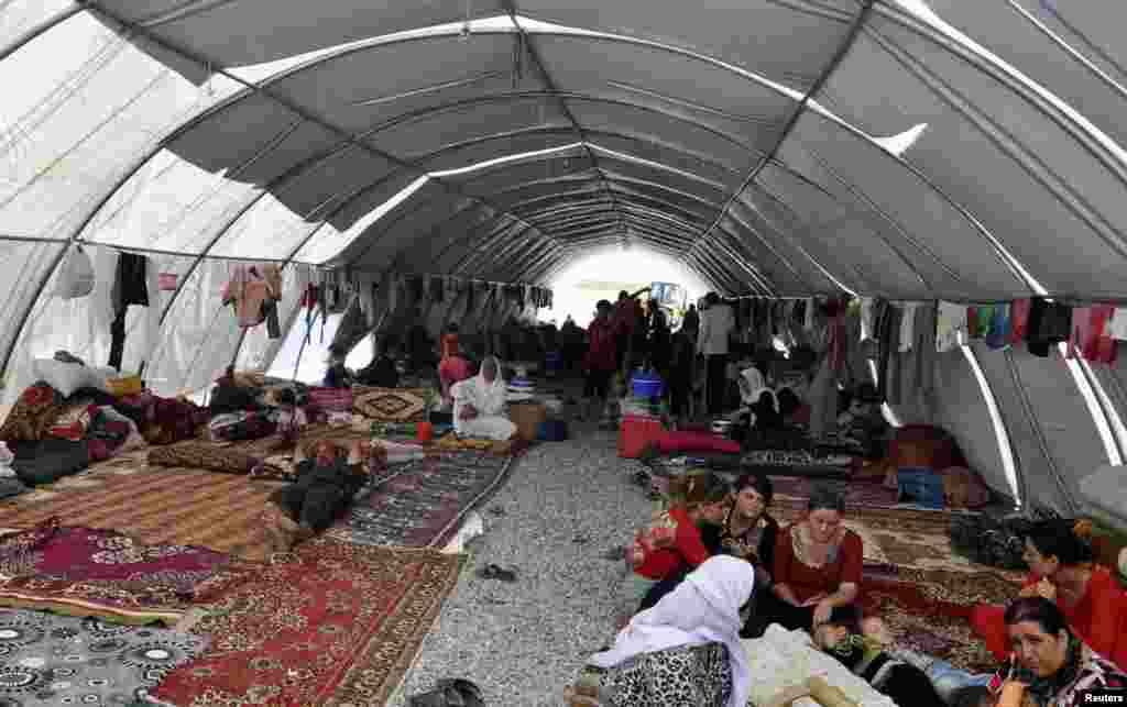 Displaced people from the minority Yazidi sect, fleeing violence in Iraq, take refuge in the southeastern Turkish town of Silopi, near the Turkish-Iraqi border crossing of Habur, Aug. 12, 2014.