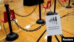 A sign for voters is seen in a polling area ahead of Election Day at the Waterville Junior High School in Waterville, Maine, Nov. 2, 2020.