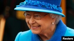 Britain's Queen Elizabeth smiles as she departs after officially opening the Scottish Borders Railway at Tweedbank Station in Scotland, Britain, Sept. 9, 2015.