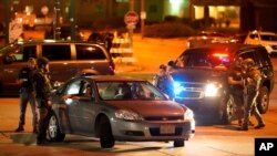 Police stop a car near where protesters gather for a fourth night to demonstrate against the police shooting of Jacob Blake in Kenosha, Wis., Aug. 26, 2020.