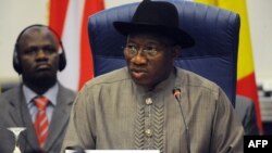 Nigerian President Goodluck Jonathan reads his opening address during an ECOWAS Summit gathering west African leaders to plot a military strategy to wrest control of northern Mali from Islamist groups as fears grow over the risks they pose to the region a