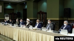 Senior officials wear face masks amid fears of COVID-19 as they attend a meeting of the Iranian government task force on the coronavirus, in Tehran, Iran, March 21, 2020.
