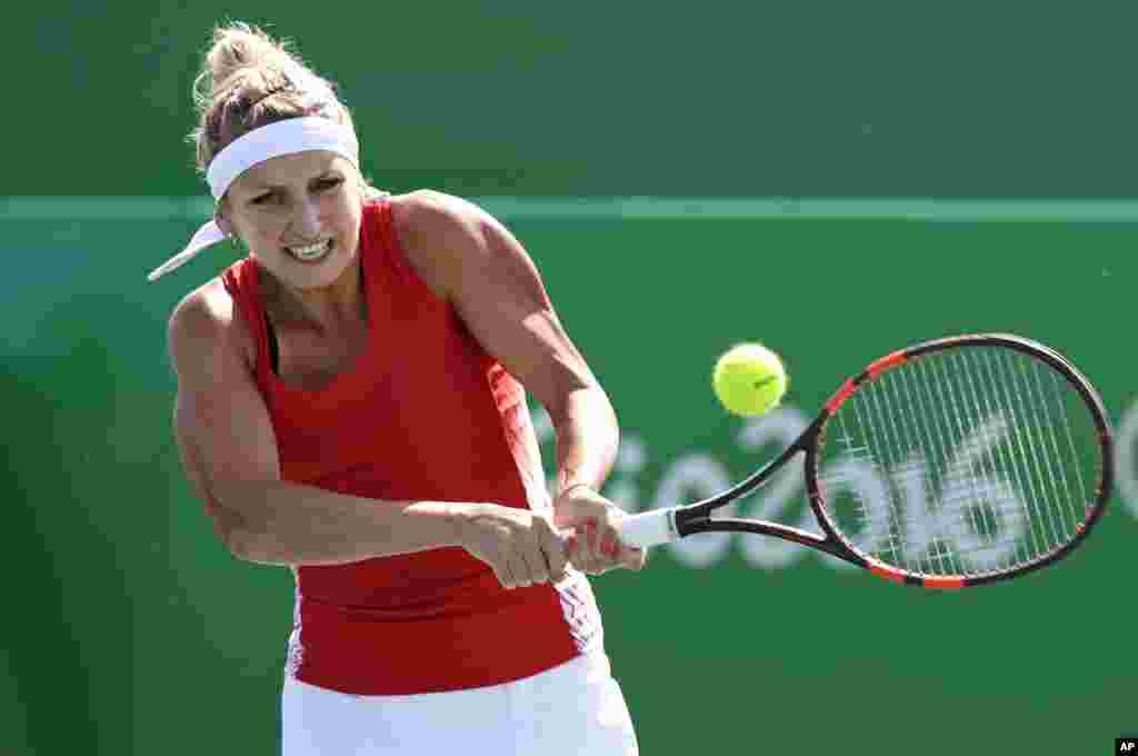 Timea Bacsinszky, of Switzerland, returns to Zhang Shuai, of China, during the 2016 Summer Olympics in Rio de Janeiro, Brazil, Aug. 6, 2016. 