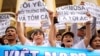 FILE - Vietnamese protesters hold banners reading "Formosa destroys the environment, which is a crime" and "I love the sea, shrimp and fish" during a rally denouncing recent mass fish deaths in Vietnam's central province, in Hanoi, Vietnam, May 1, 2016.