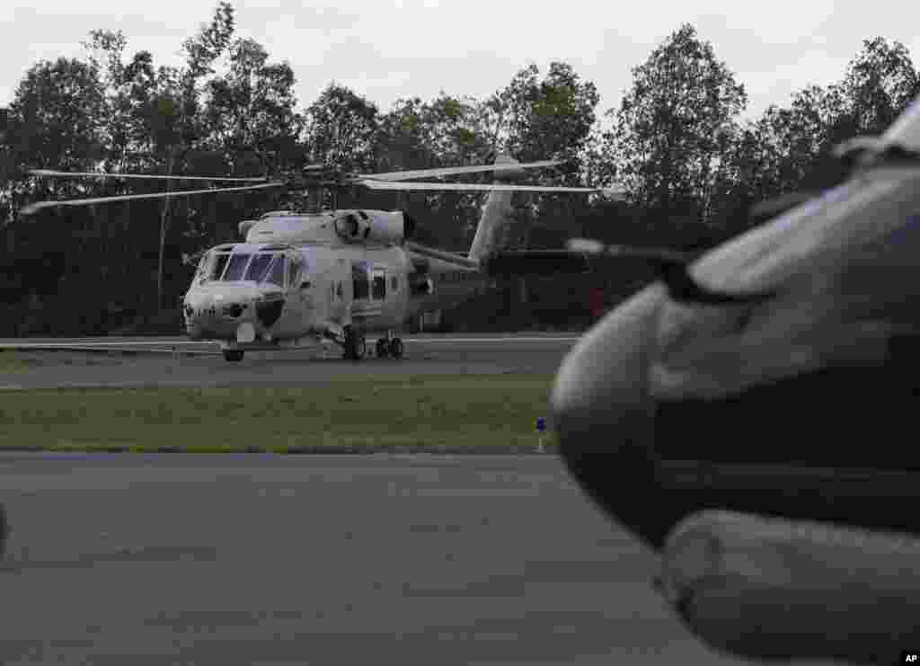 A Japan Maritime Self-Defense Force helicopter returns from a search operation for the victims of AirAsia Flight 8501, at the airport in Pangkalan Bun, Indonesia, Jan. 7, 2015.