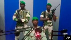In this image from TV, a soldier who identified himself as Lt. Obiang Ondo Kelly, commander of the Republican Guard, reads a statement on state television broadcast from Libreville, saying the military has seized control of the government, Jan. 7, 2019.