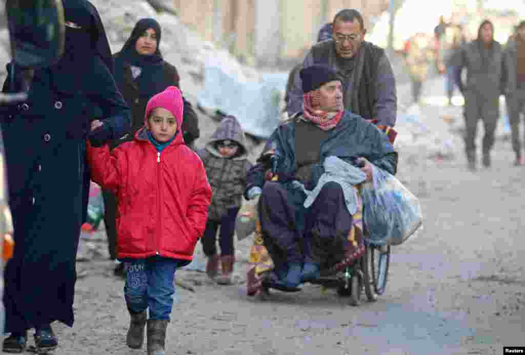 People walk as they gather to be evacuated from a rebel-held sector of eastern Aleppo, Syria Dec. 15, 2016. 