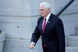Vice President Mike Pence walks to the West Wing of the White House after addressing staff on the steps of the Eisenhower Executive Office Building, in the White House complex, January 19, 2021, in Washington.