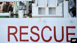 FILE -- Migrants wait to disembark from Italian coast guard ship in Sicily, Italy, Aug. 29, 2015. The Italian coast guard rescued nearly 6,000 migrants in one day from the sea October 3, 2016.