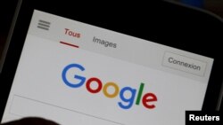 FILE - A man holds his smartphone which displays the Google home page, in this picture illustration taken in Bordeaux, Aug. 22, 2016. 