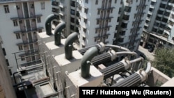 A view of a device created by company Chakr Innovation to remove soot from diesel general exhaust, to clean the air and to allow ink to be created from soot, on a building in Gurgaon, a satellite city of New Delhi, India, March 19, 2018. 