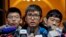 Pro-democracy activist Alex Chow, center, speaks to reporters outside the Court of Final Appeal in Hong Kong, Feb. 6, 2018. 