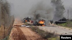 Hezbollah claimed responsibility for an attack Wednesday on an Israeli military convoy. Burning vehicles are seen near the village of Ghajar on Israel's border with Lebanon, Jan. 28, 2015. 