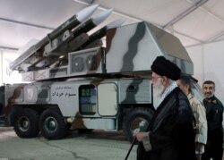 Iran's Supreme Leader Ayatollah Ali Khamenei is seen near a "3 Khordad" system which is said to had been used to shoot down a U.S. military drone.