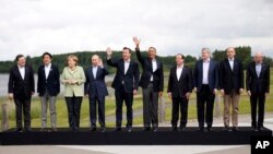 FILE - Leaders pose during a group photo opportunity during the G8 summit at the Lough Erne golf resort in Enniskillen, Northern Ireland, on June 18, 2013. This year's G8 Summit will be hosted by Vladimir Putin in Sochi, Russia June 4-5. 