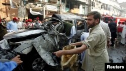 Security officers collect evidence from the site of a suicide bomb attack in Peshawar, November 7, 2012. 