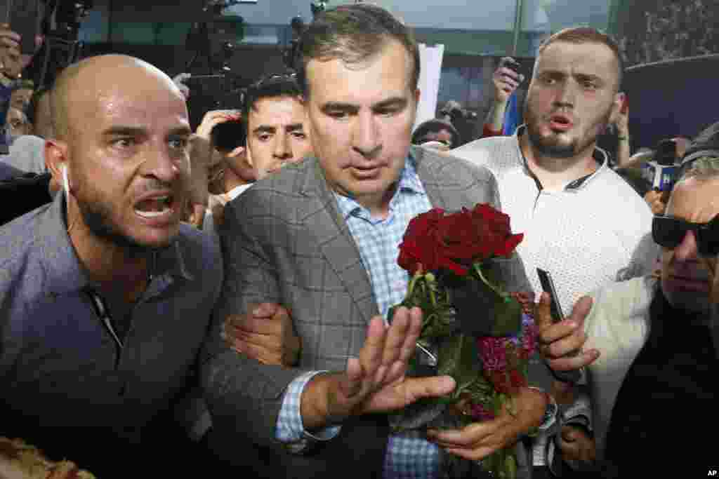 From left to right, Reuters Pulitzer winners for International Reporting: Simon Lews, Kyaw Soe Oo, Poppy McPherson, Shoon Naing, Anthony Slodkoski, Wa Lone, and Columbia University president Lee Bollinger, inside Low Library at Columbia University in New York, May 28, 2019.