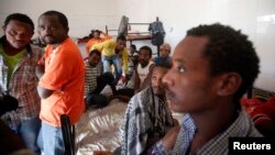 FILE - African migrants are seen in their dormitory at a detention center in Sorman, 55 km (34 miles) west of Tripoli, Libya.