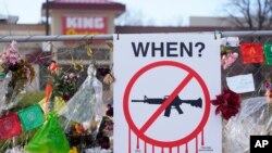 Tributes hang on the temporary fence surrounding the parking lot in front of a King Soopers grocery store in which 10 people died in a late March mass shooting, April 9, 2021, in Boulder, Colo. 