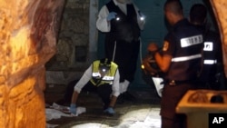 Israeli forensics experts inspect the scene of an attack in Jerusalem's Old City, Oct. 3, 2015.