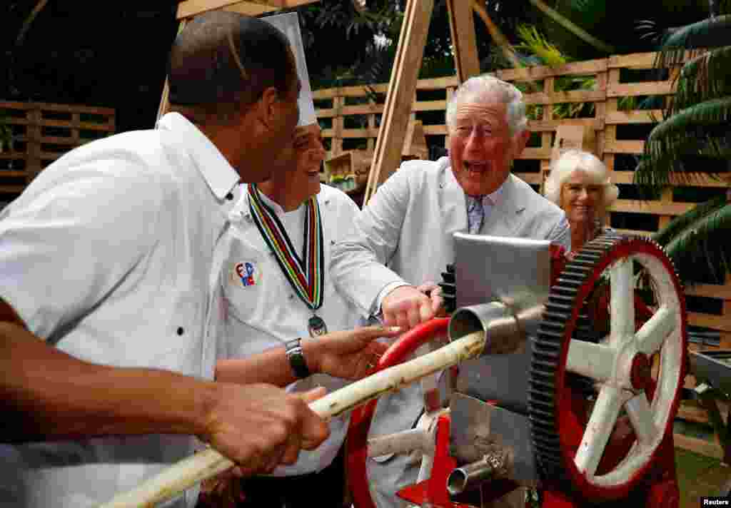 Britain&#39;s Prince Charles presses sugar cane to make juice during a visit to a paladar, a private restaurant, in Havana, Cuba.
