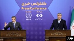 Iran's head of the Atomic Energy Organisation Mohammad Eslami (R) and the United Nations nuclear chief Rafael Grossi give a joint press conference in Tehran on November 14, 2024.
