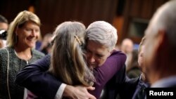Le juge conservateur Neil Gorsuch sert sa famille dans ses bras lors d'une audience à Washington, le 22 mars 2017.