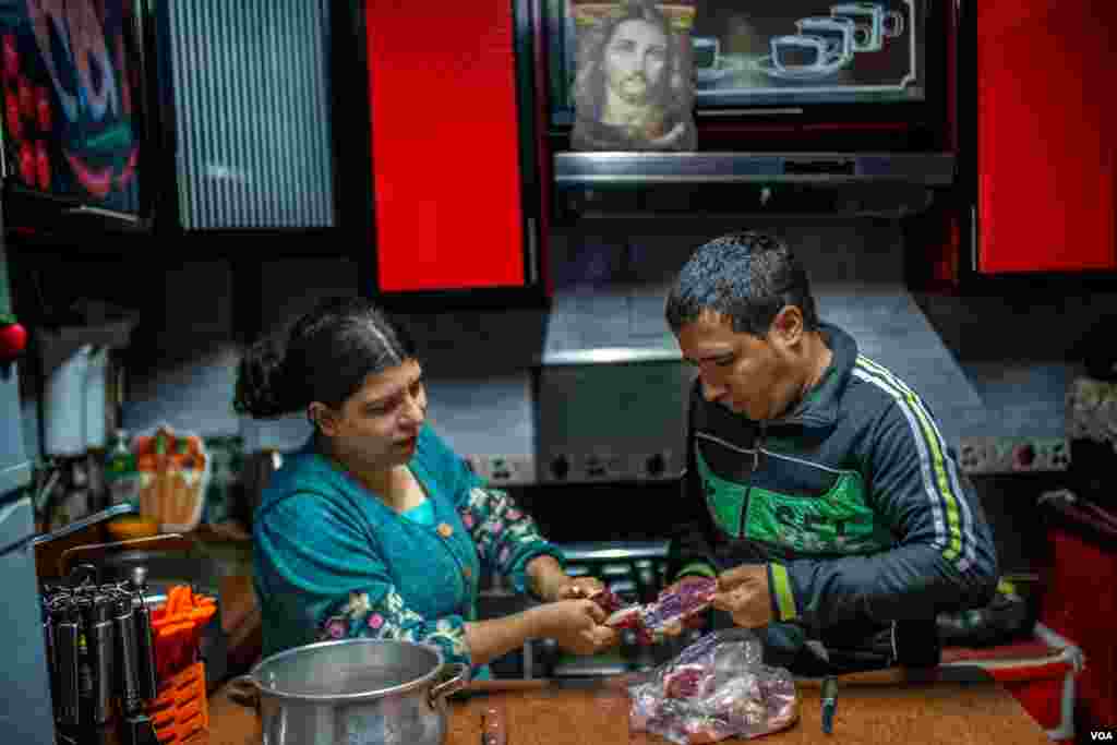 Musa Nazmy, 32, a baker, helps his wife Marina prepare Christmas dinner in Cairo, Jan. 6, 2021. (H. Elrasam/VOA) 