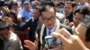  Sam Rainsy talks to the media outside the airport gate before beginning his walk into Phnom Penh, Cambodia, August 16, 2013. (Robert Carmichael for VOA)