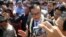  Sam Rainsy talks to the media outside the airport gate before beginning his walk into Phnom Penh, Cambodia, August 16, 2013. (Robert Carmichael for VOA)