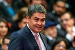 FILE - Honduras' President Juan Orlando Hernandez arrives for a swearing-in ceremony in Guatemala City, Jan. 14, 2020.