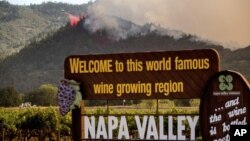 FILE - In this Sept. 27, 2020, file photo, an air tanker drops retardant on the Glass Fire burning in Calistoga, Calif. (AP Photo/Noah Berger, File)