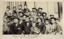 FILE - This photo made available by the Presbyterian Historical Society, Philadelphia, shows students at a Presbyterian boarding school in Sitka, Alaska, in the summer of 1883.